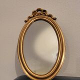 Miroir ovale à noeud doré  en bois