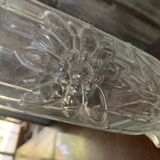 Transparent glass vase with relief floral decoration from the 1980s, fluted neck and polygonal base.