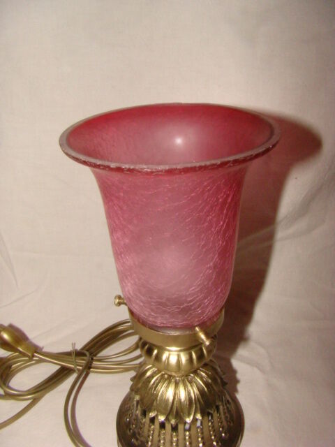 bronze bedside lamp with a pink cracked glass shade