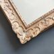 Large Montparnasse rocaille style frame in carved wood mounted in mirror.
