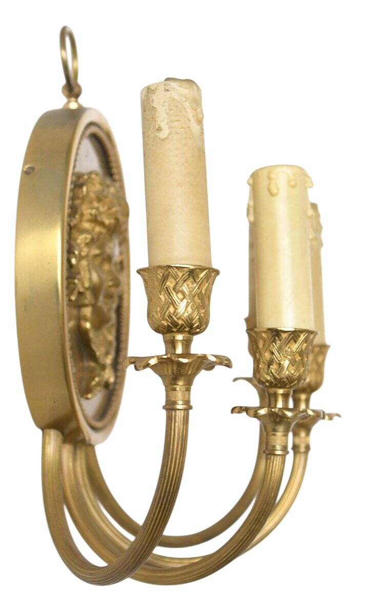 Pair of wall sconces with a relief decoration of a Bacchus mask.