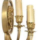 Pair of wall sconces with a relief decoration of a Bacchus mask.