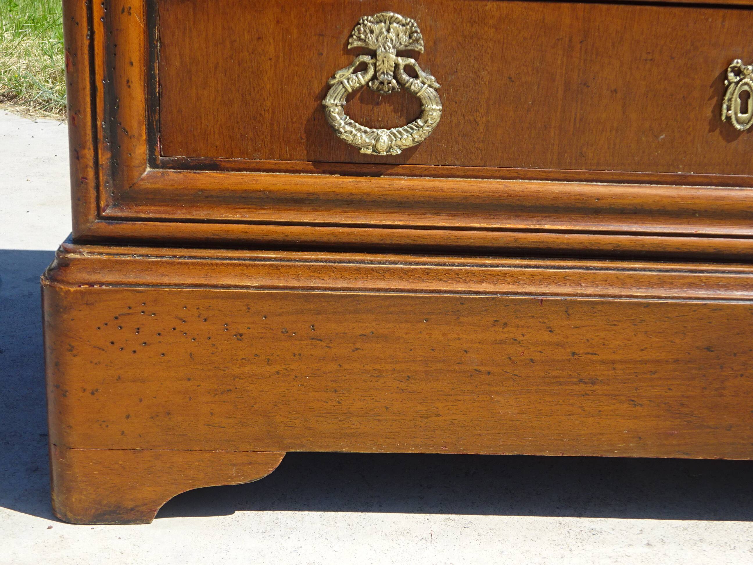 Chest of drawers with decorated handles in the Louis XVI style.