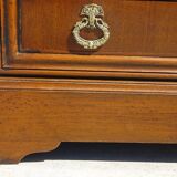 Chest of drawers with decorated handles in the Louis XVI style.