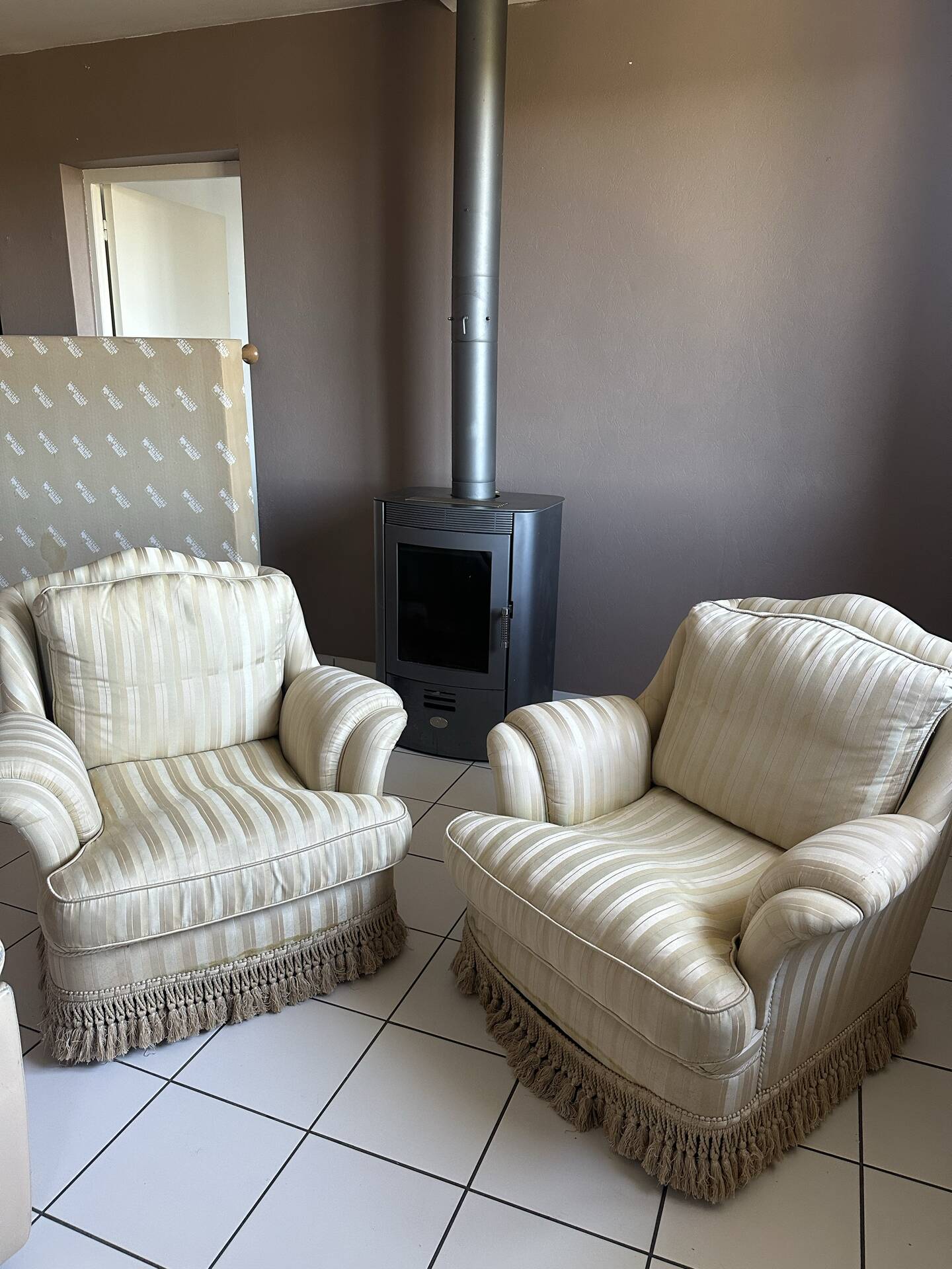 Pair of vintage bergère armchairs in striped ecru and beige fabric.