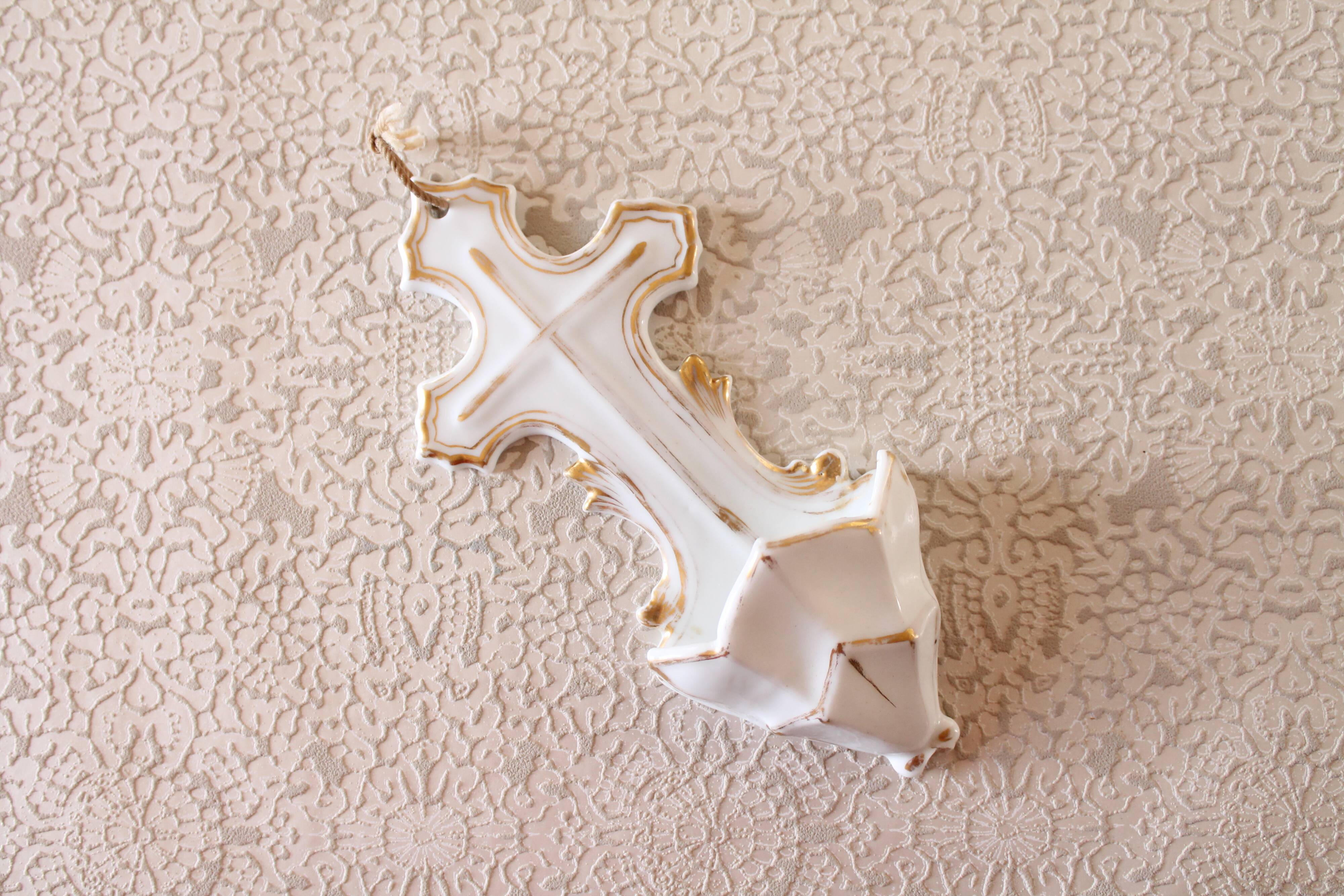 Antique holy water font in white porcelain biscuit.