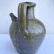 Ancient oil jar in glazed terracotta, khaki green — Auvergne, Lezou