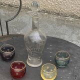 Liqueur carafe, or aperitif, carved with floral decoration in transparent glass and 4 polka dot glasses