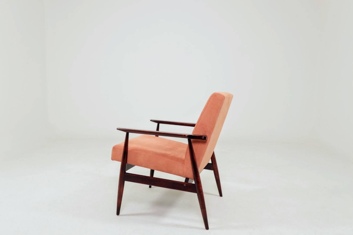 Mid-century modern armchair in coral red designed by H. Lis.