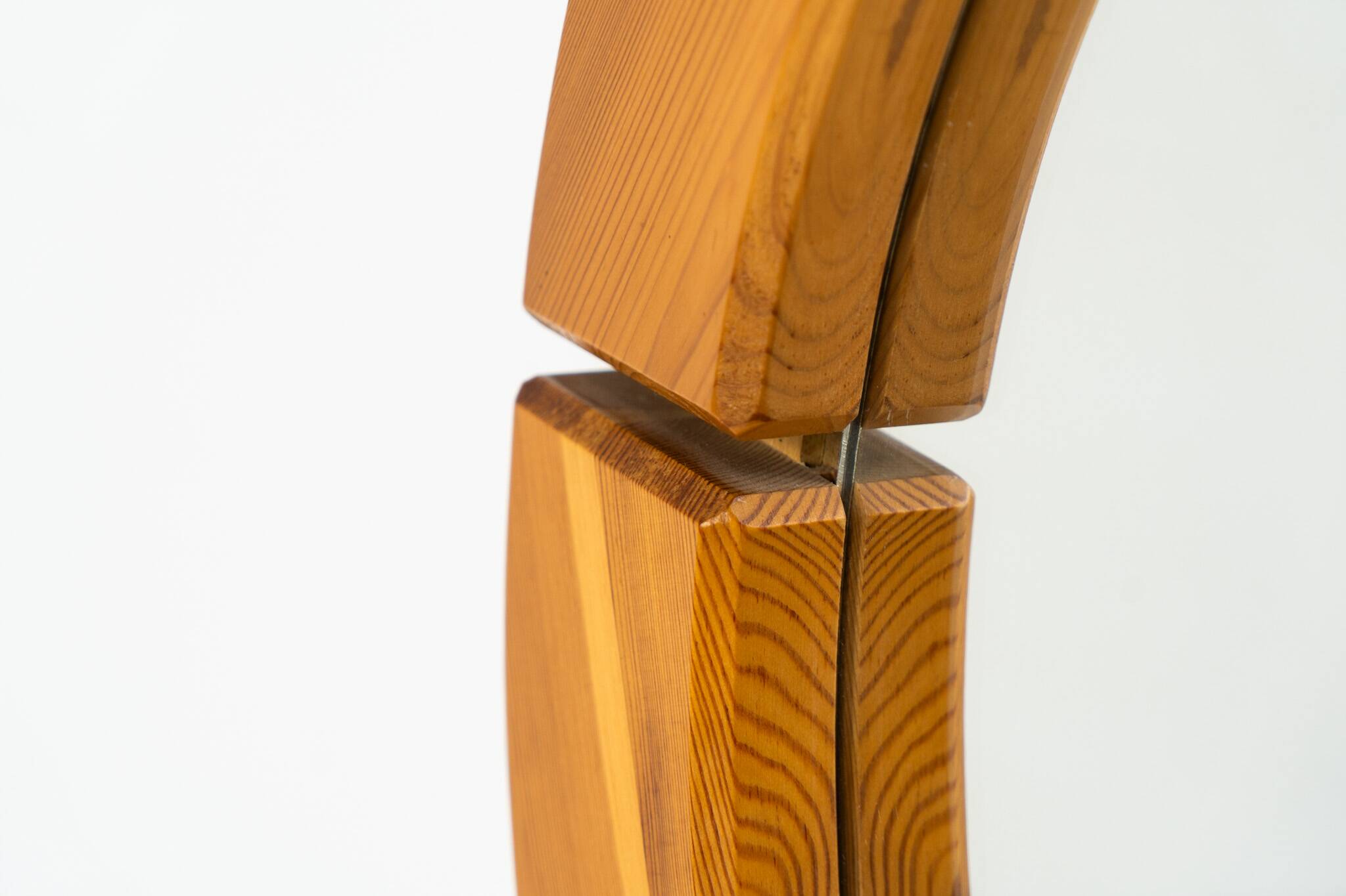 Sculptural wall mirror in solid pine
