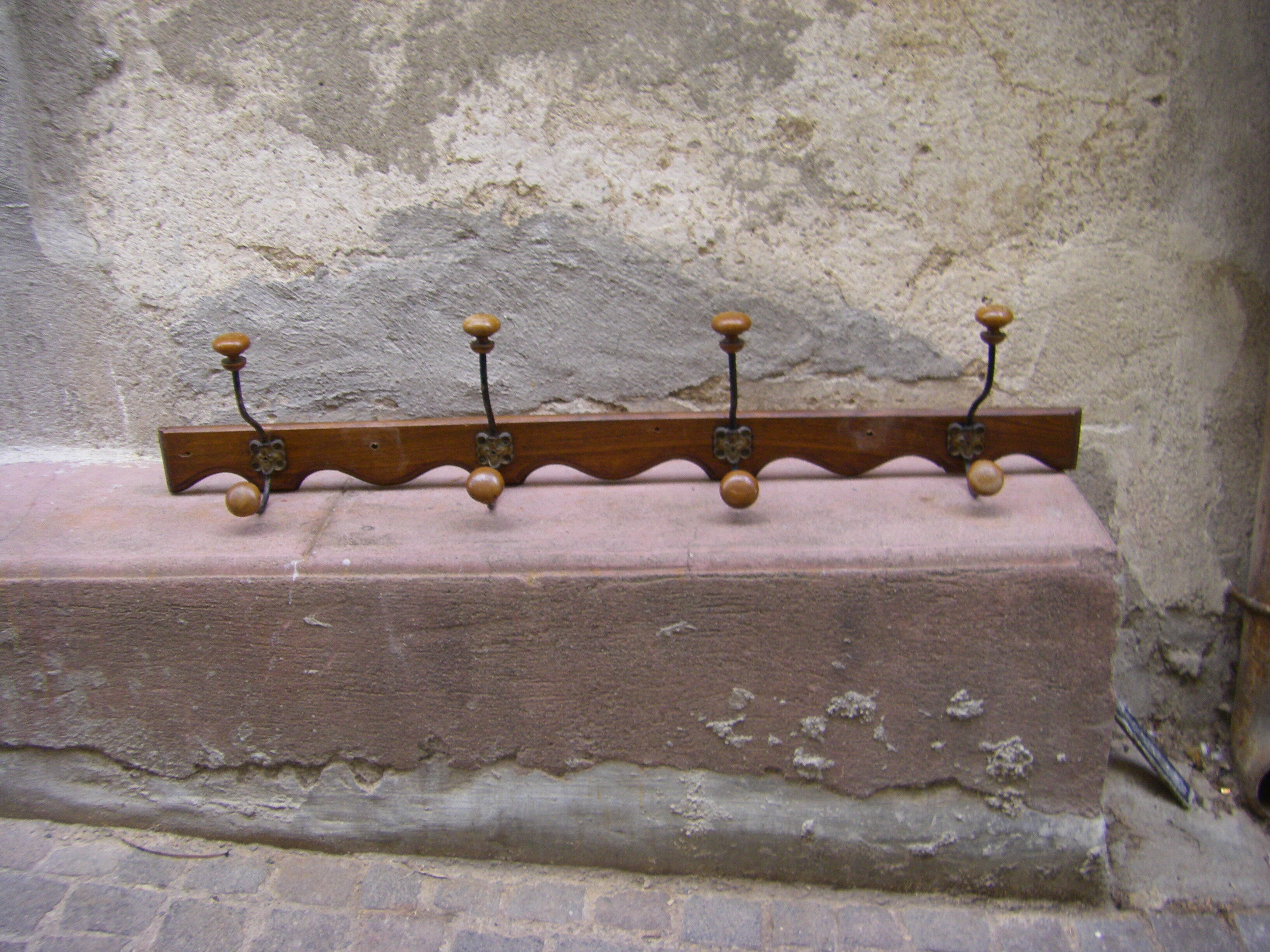 Wall coat rack has four hooks