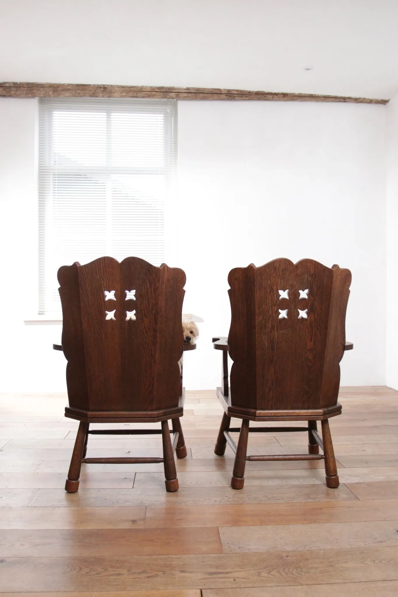 Pair of brutalist oak lounge chairs with rush seats, circa 1935