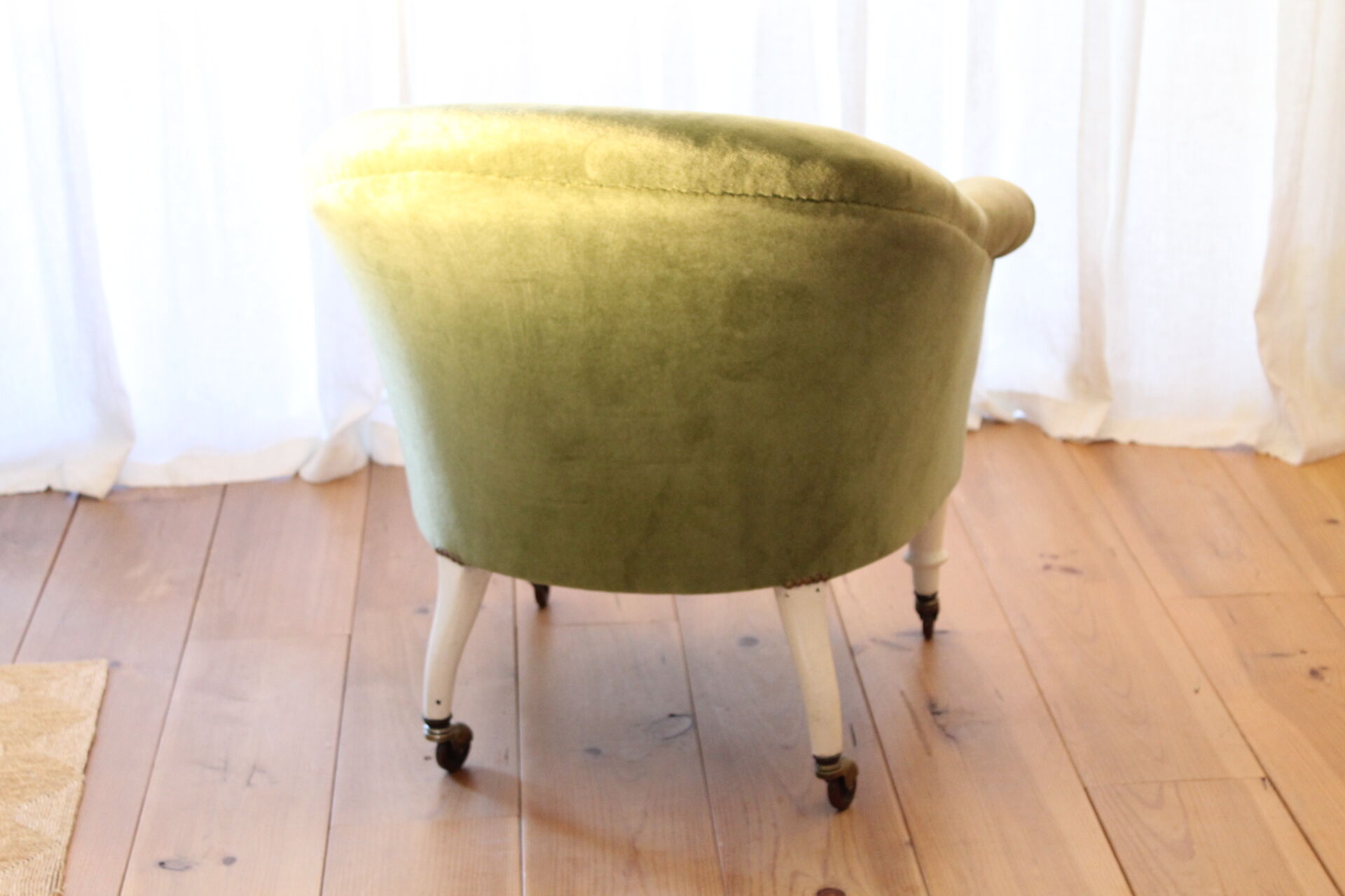 Toad in almond green velvet armchair on castors