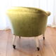 Toad in almond green velvet armchair on castors