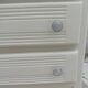 Vintage commode enhanced in beige, wooden top.