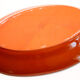 Portuguese XL dish in orange enamelled clay with unbleached flowers and green leaves