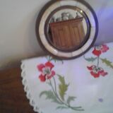 Round mirror bordered with copper