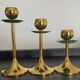 Trio of vintage brass candlesticks