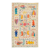 White suzani kilim rug with embroidered colorful patterns