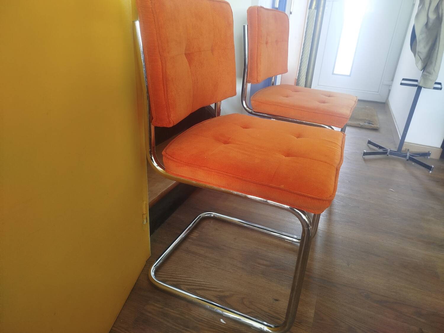 Pair of vintage cantilever chairs in chrome and orange corduroy.