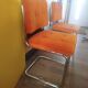 Pair of vintage cantilever chairs in chrome and orange corduroy.