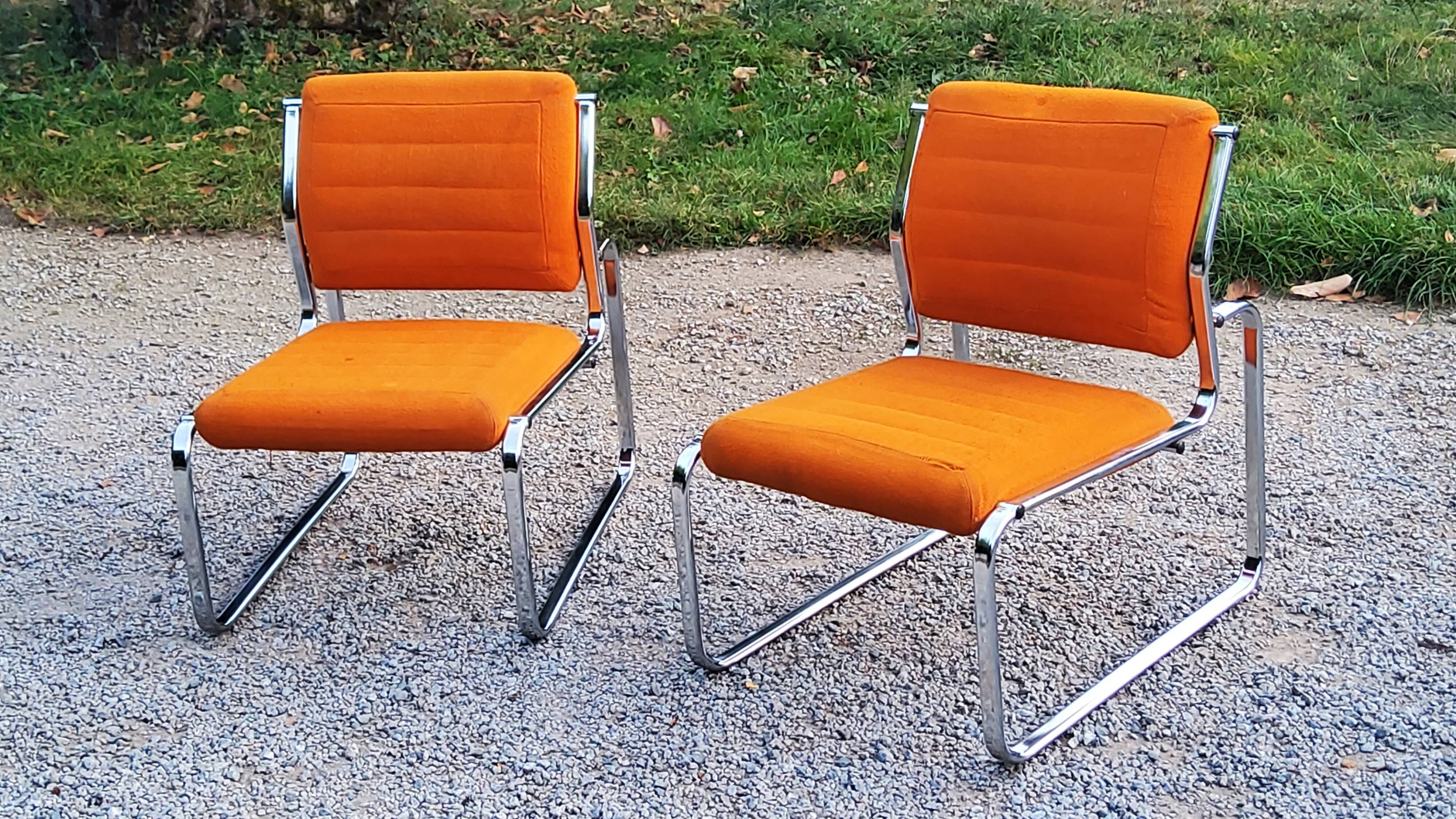 Pair of designer armchairs in orange fabrics and chrome tubes from the 70s