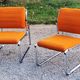 Pair of designer armchairs in orange fabrics and chrome tubes from the 70s