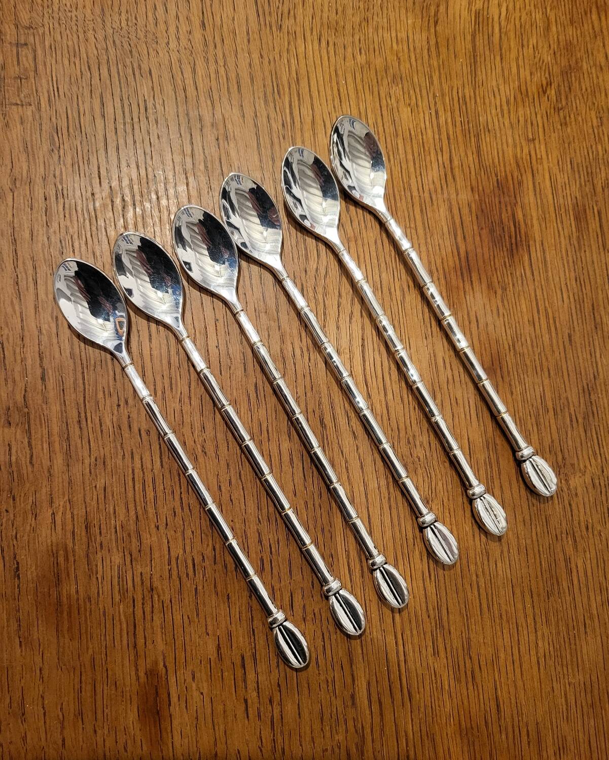 6 long silver-plated metal spoons
