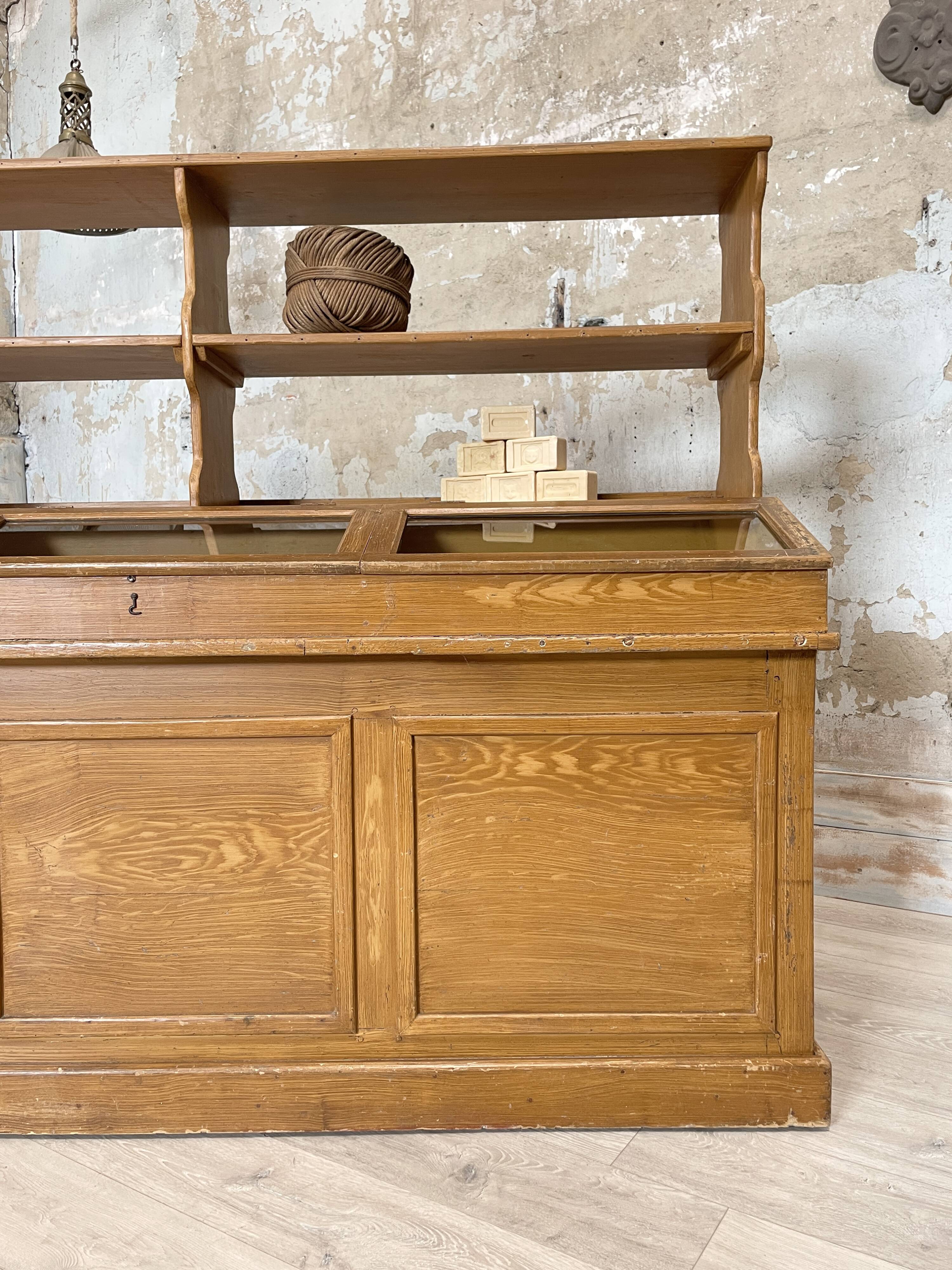 Wooden hardware cabinet painted with wood effect, circa 1940.