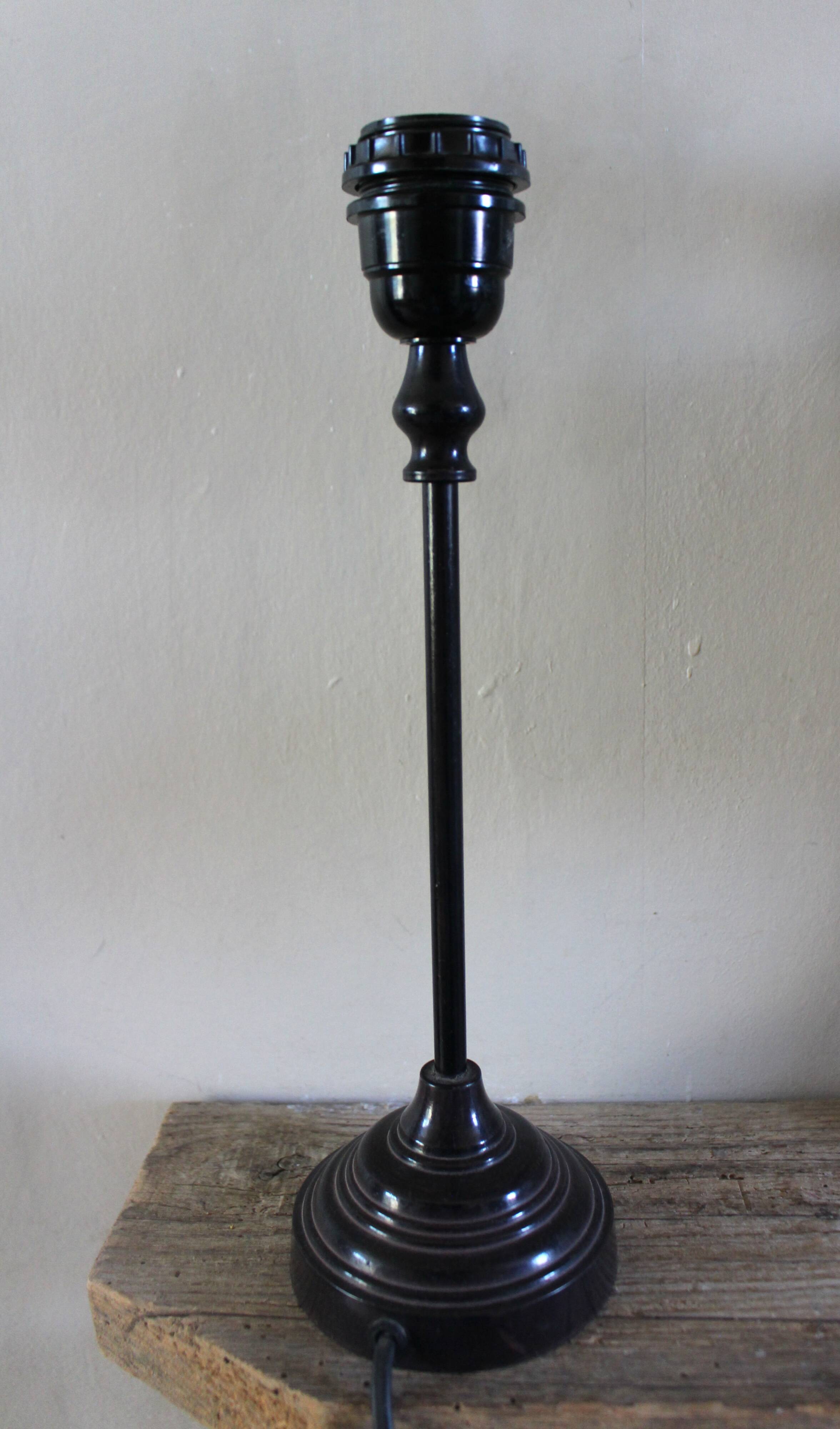 Table lamp with a patinated base and vintage woven shade.