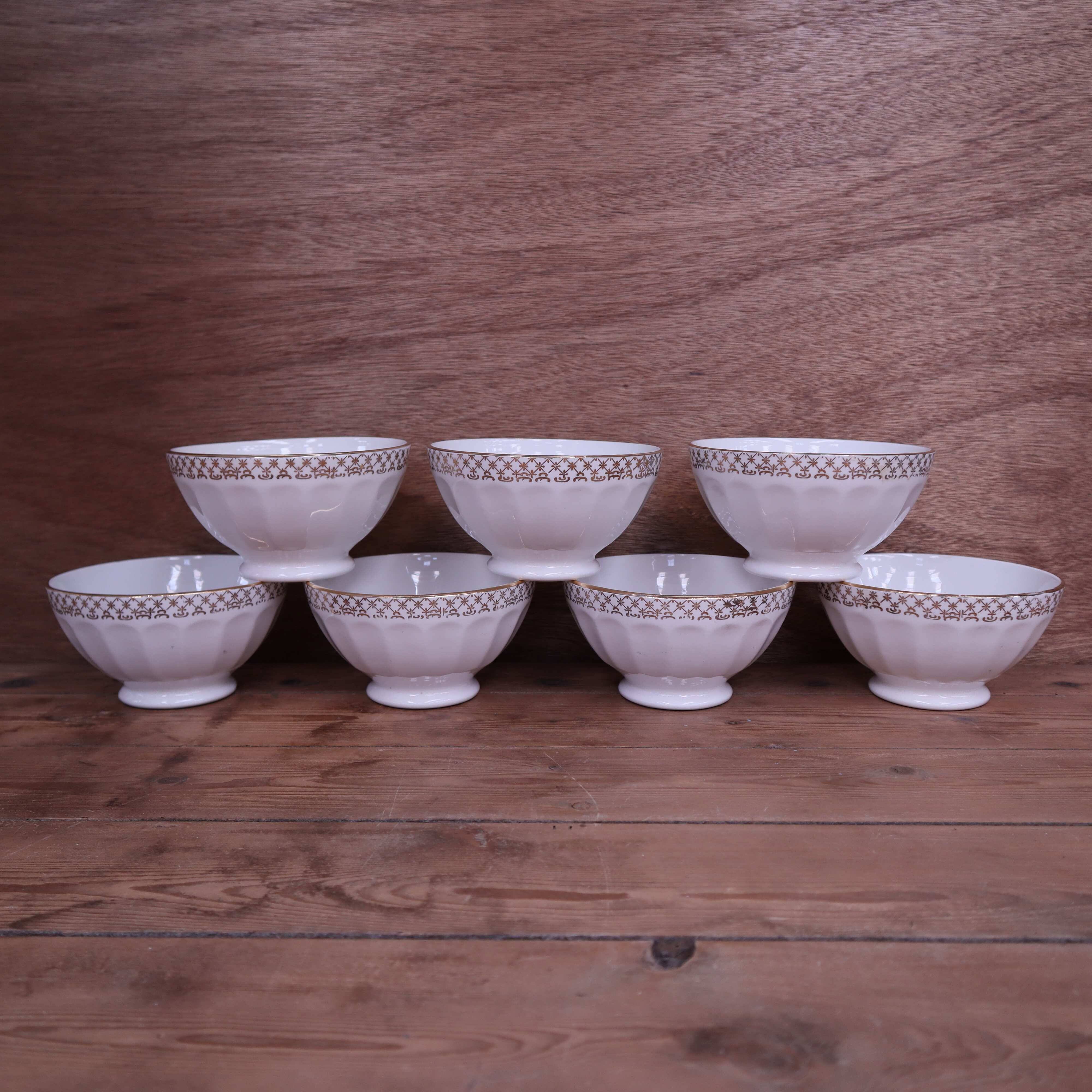 Antique white ribbed porcelain bowl with gold frieze