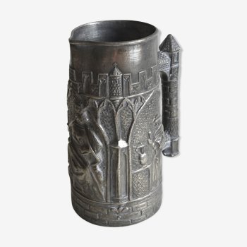 Carved tin pitcher