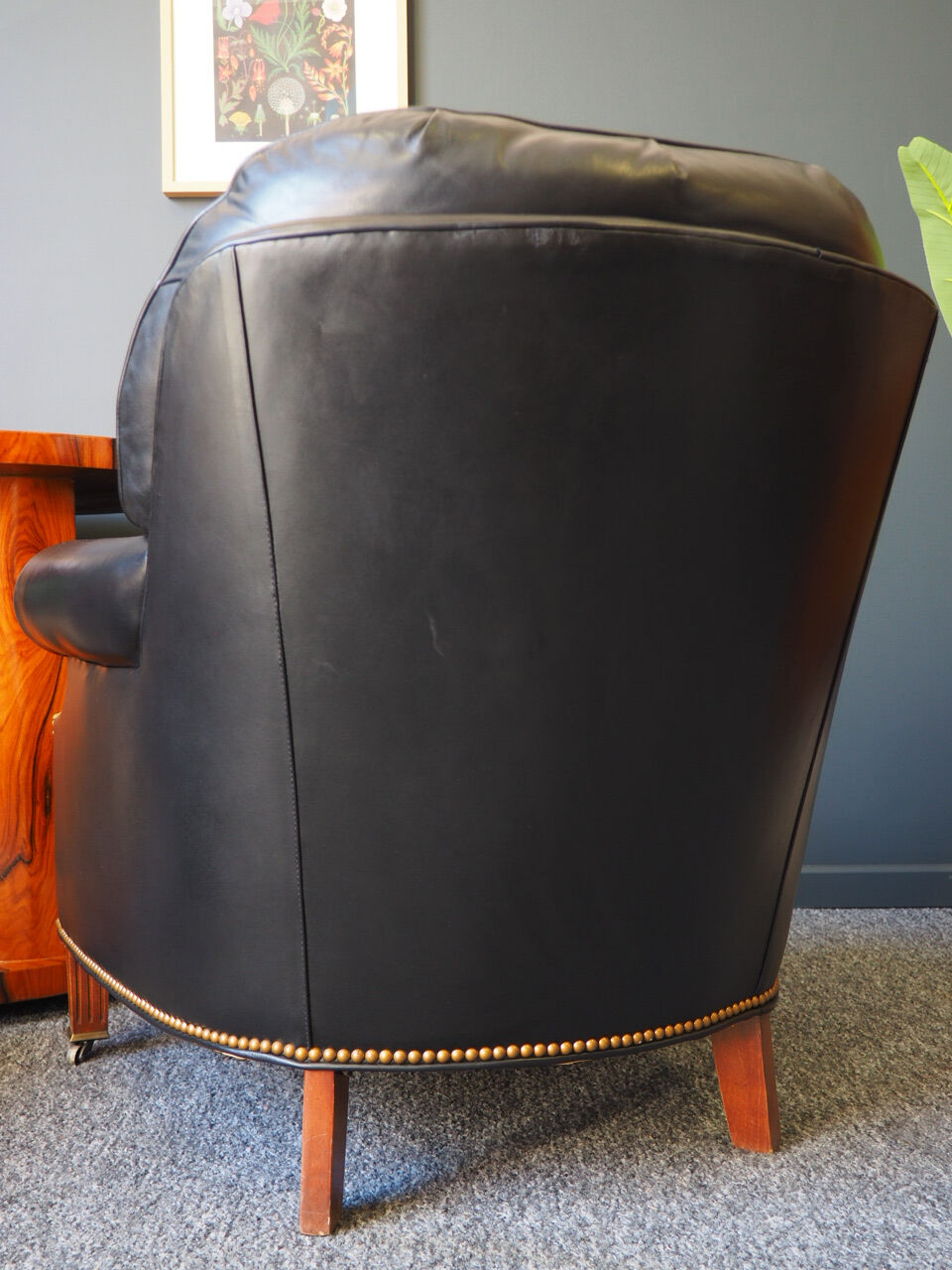 Chesterfield style leather armchair & footstool by Hancock & Moore