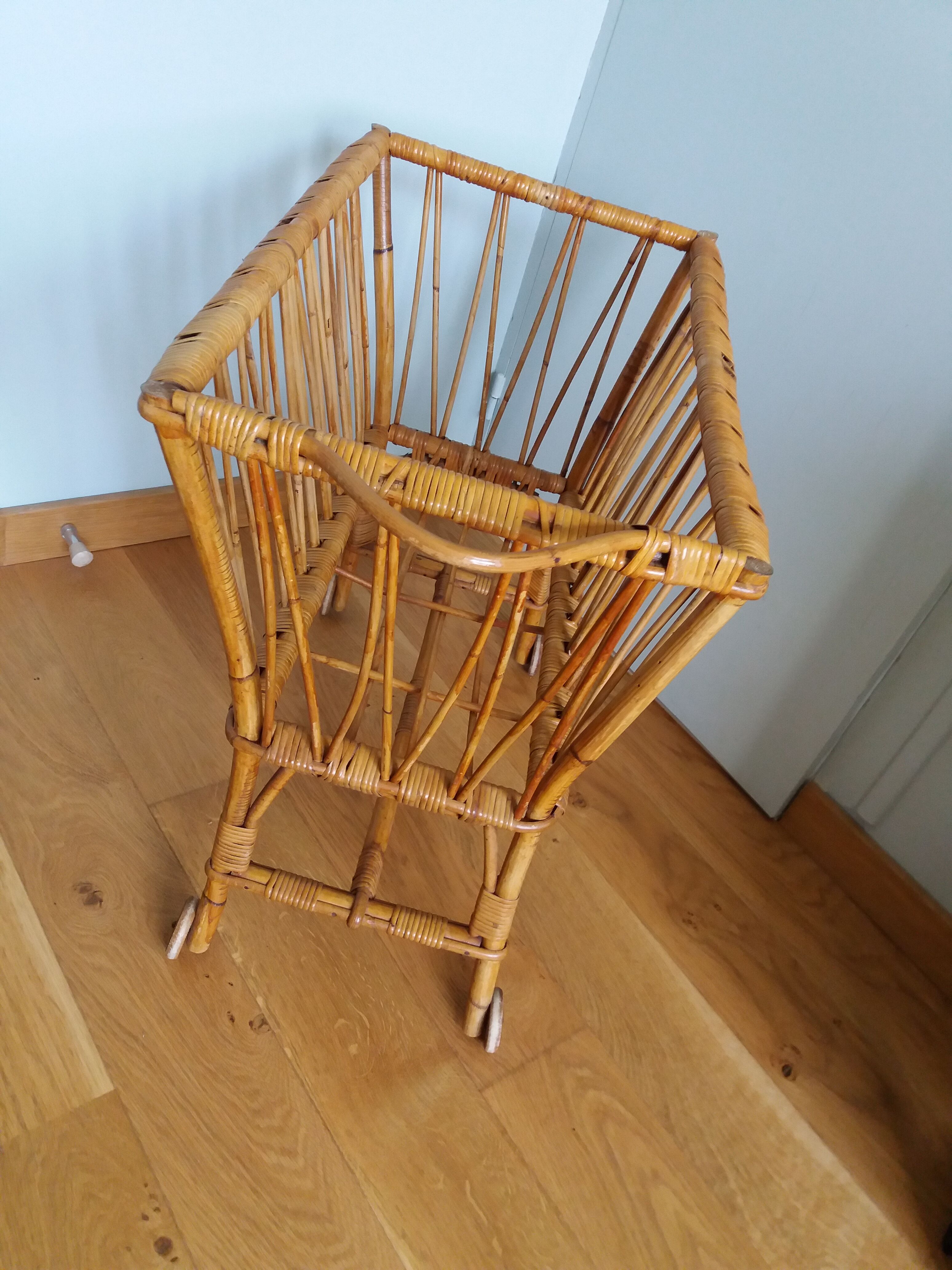 Rattan wicker cradle on wooden wheels