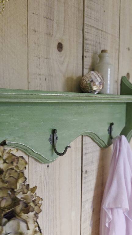 Antique wall shelf with a green patina
