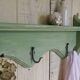 Antique wall shelf with a green patina