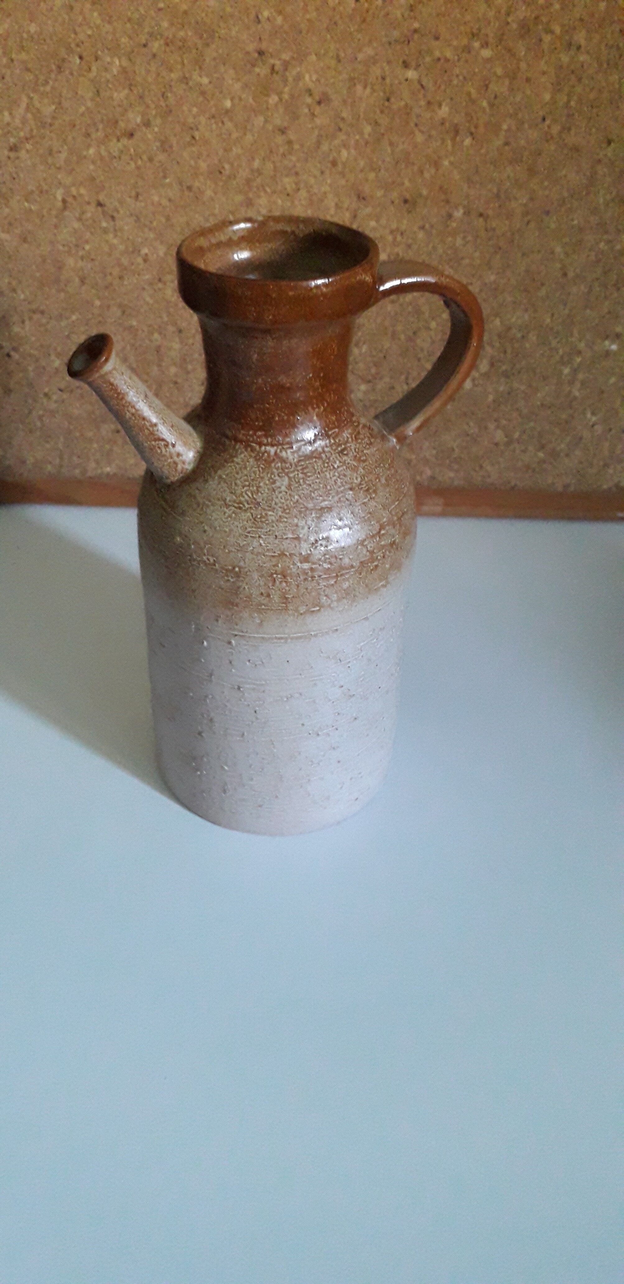 Vintage kid jug in two-tone sandstone with a handle and spout