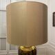 Bronze table lamp with a golden shade.