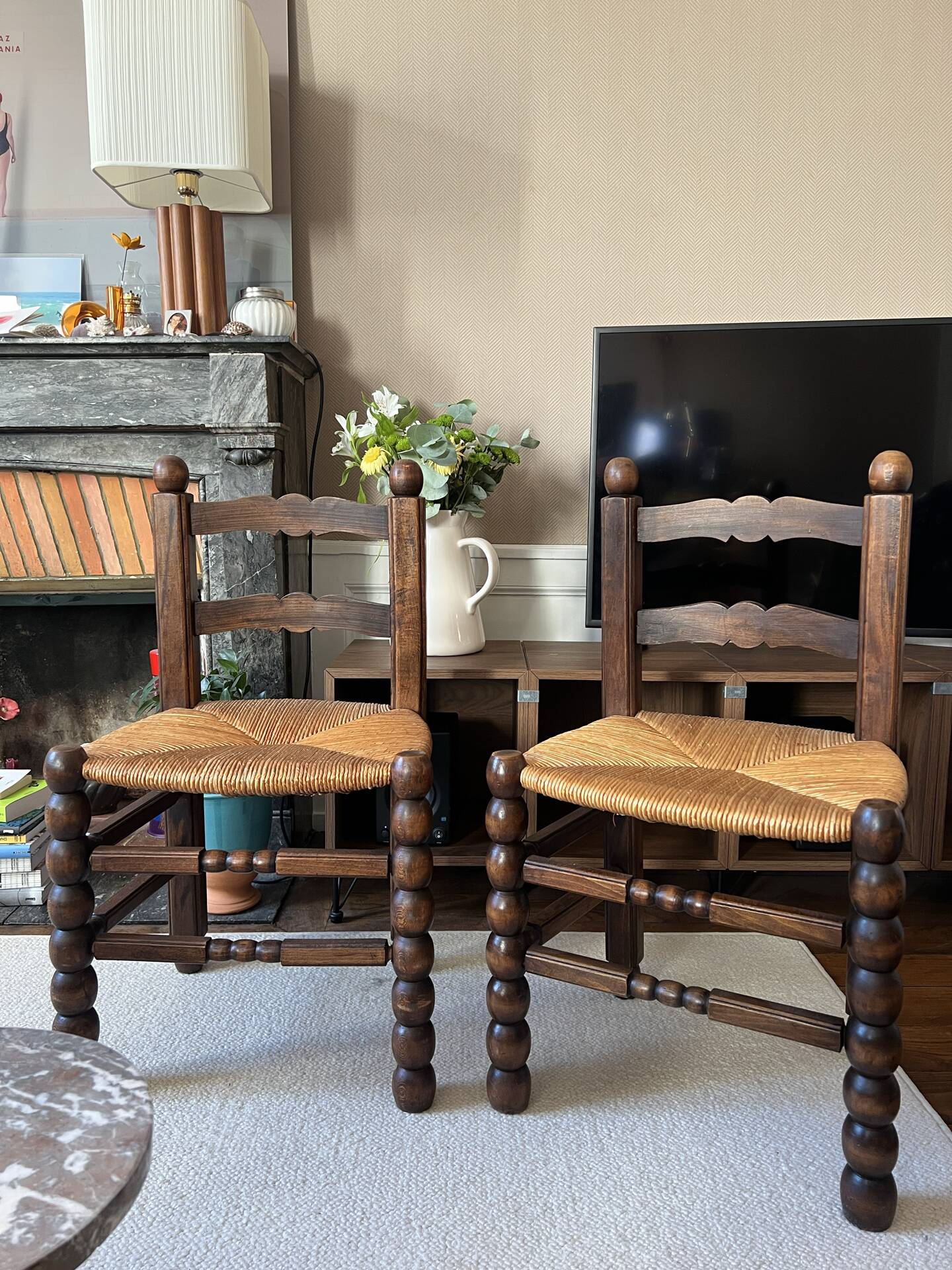 Pair of vintage armchairs with turned wood and woven rope seat.