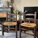 Pair of vintage armchairs with turned wood and woven rope seat.