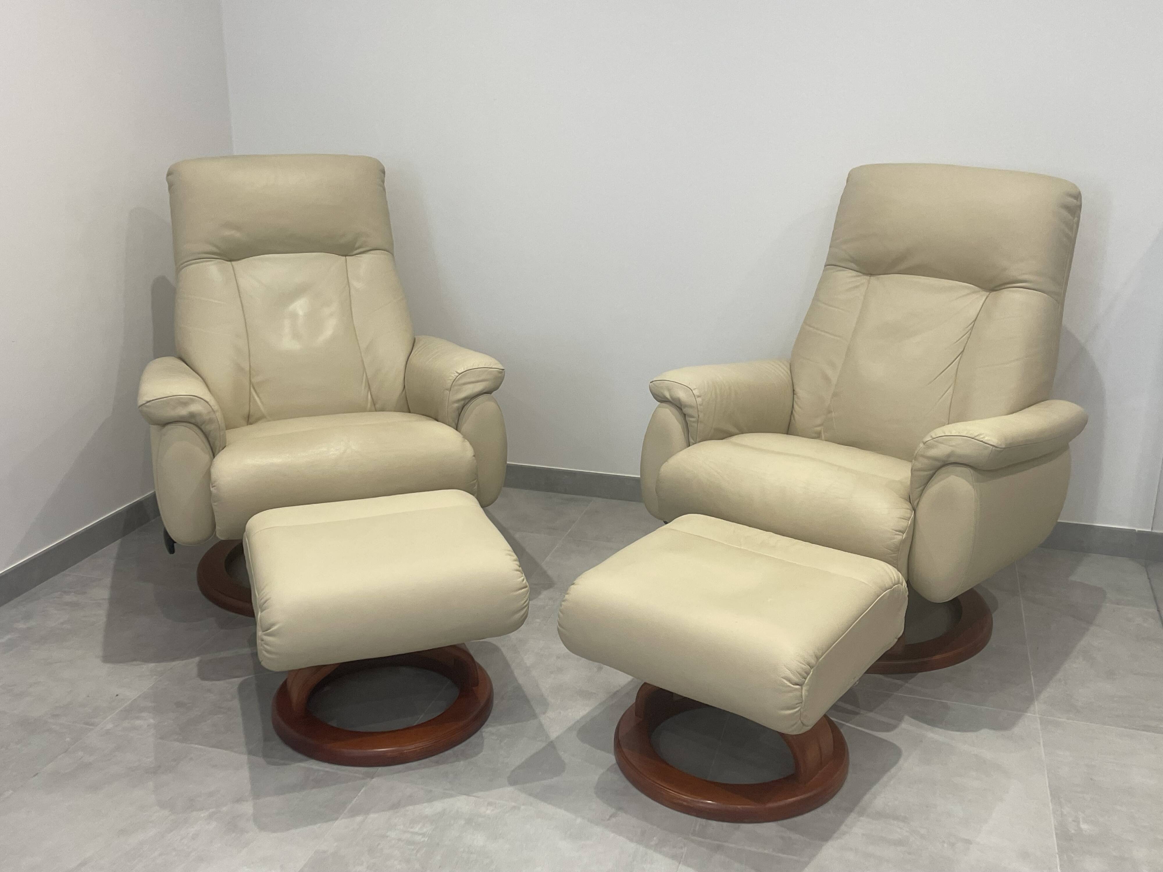Pair of vintage leather armchairs with ottoman