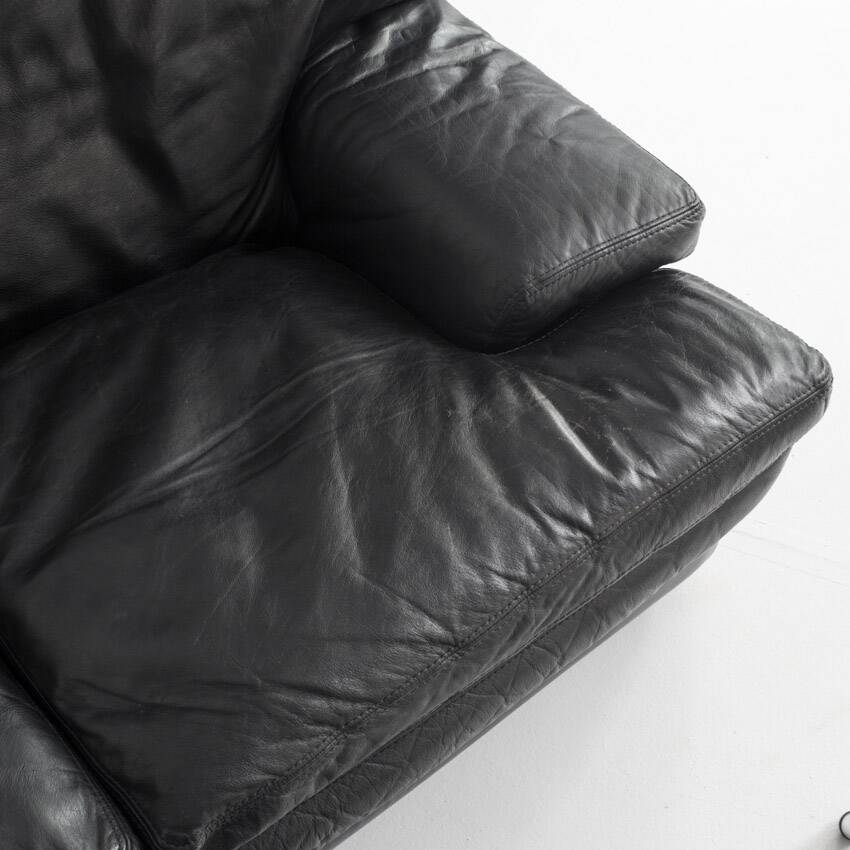 Black leather two-seater sofa. Roche Bobois edition. France, 1980s.