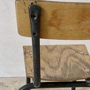 Vintage children's school chair in wood and black metal, industrial style.