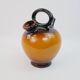 Ochre-orange ceramic jug signed under the base CP Claude Paci