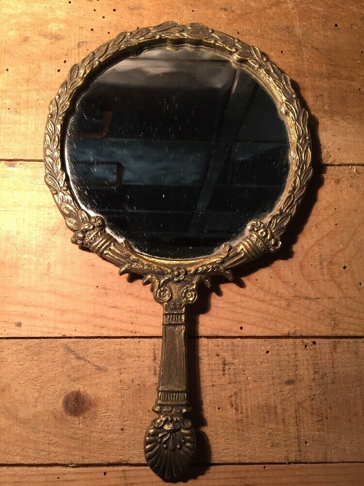 Antique mirror facing round hand in bronze 23cm