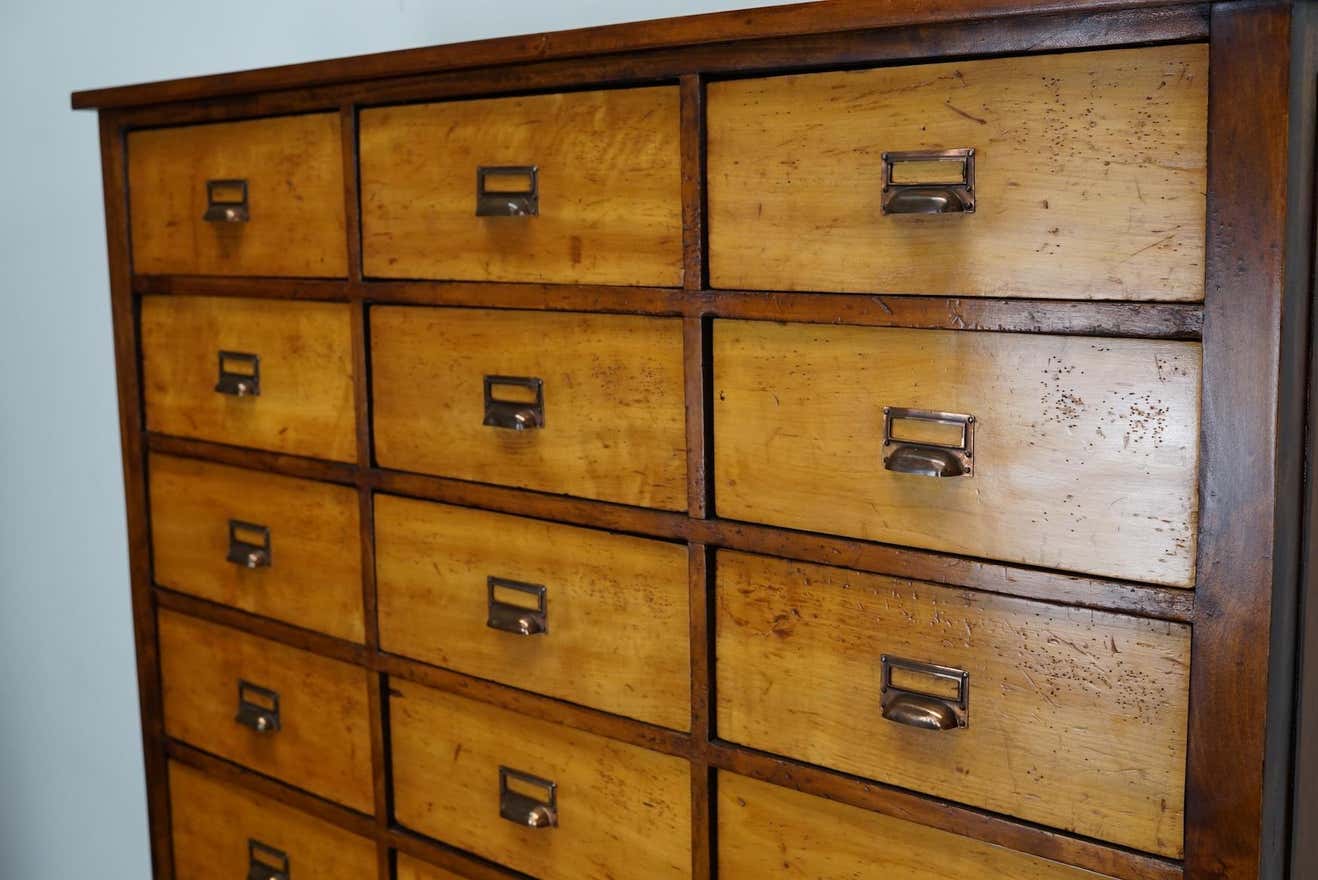 School cabinet bank of vintage Dutch drawers in mid-twentieth century pine