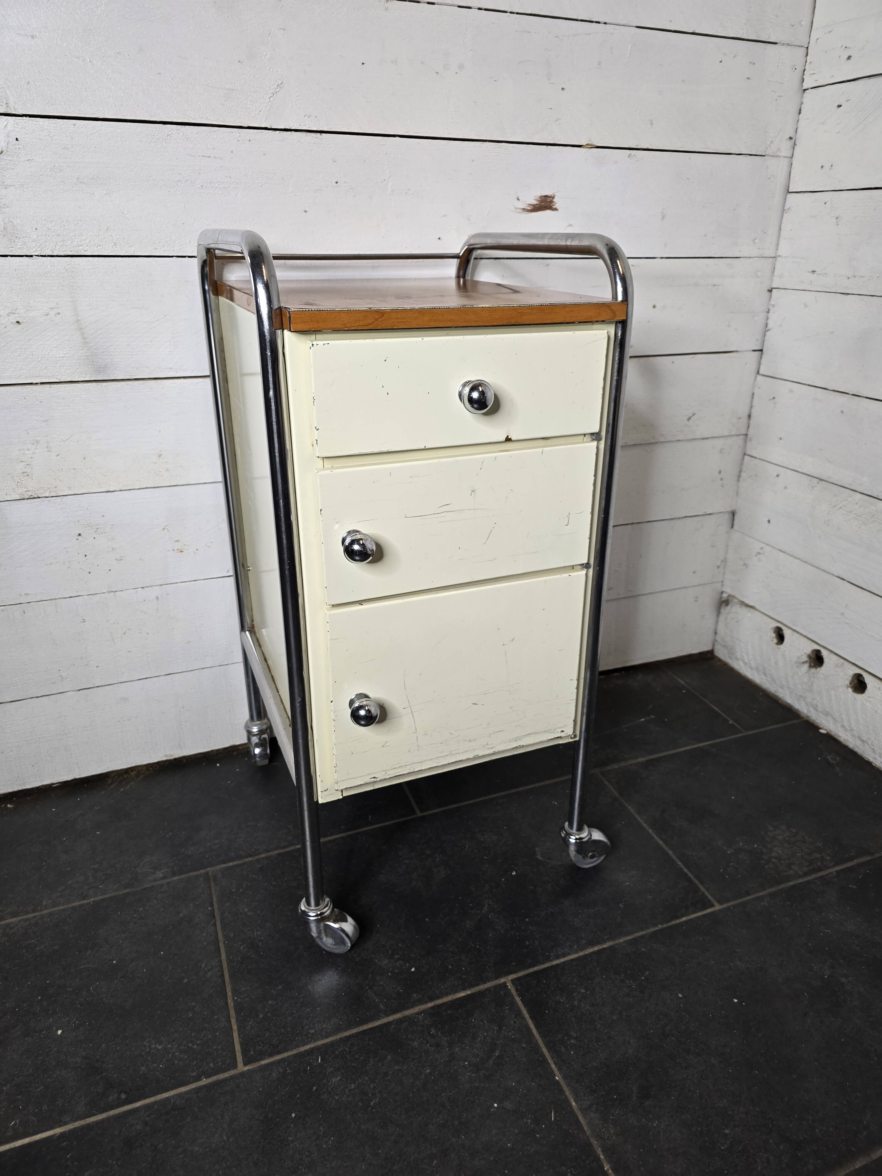 Mid-20th century metal cabinet table on wheels