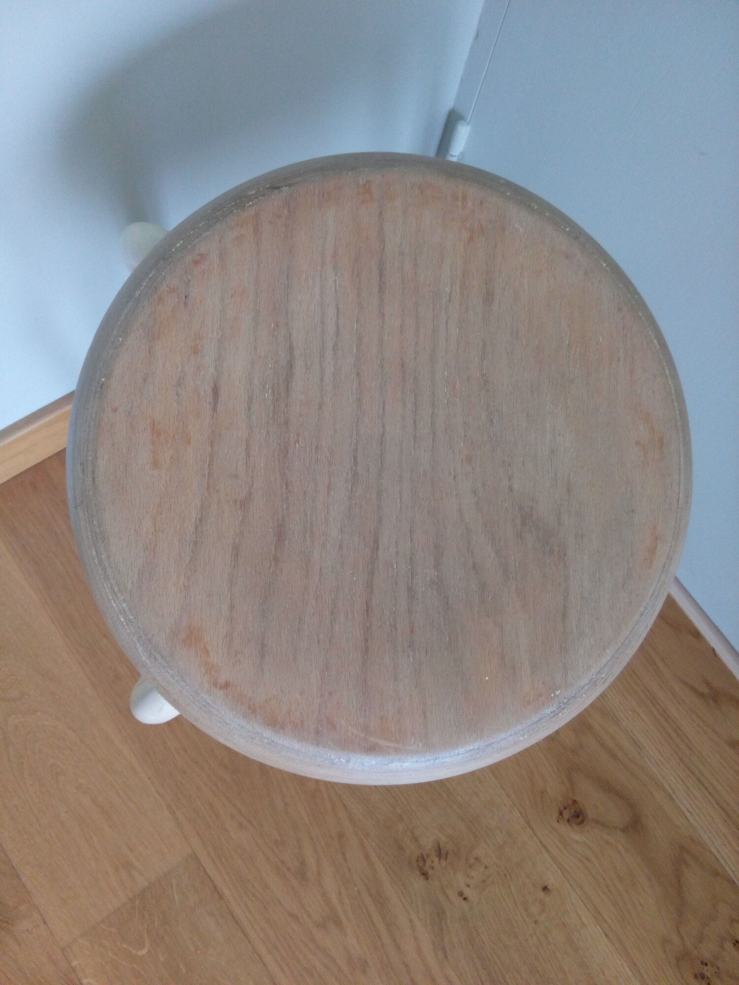 Industrial tubular metal stick sitting round in wood