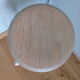 Industrial tubular metal stick sitting round in wood