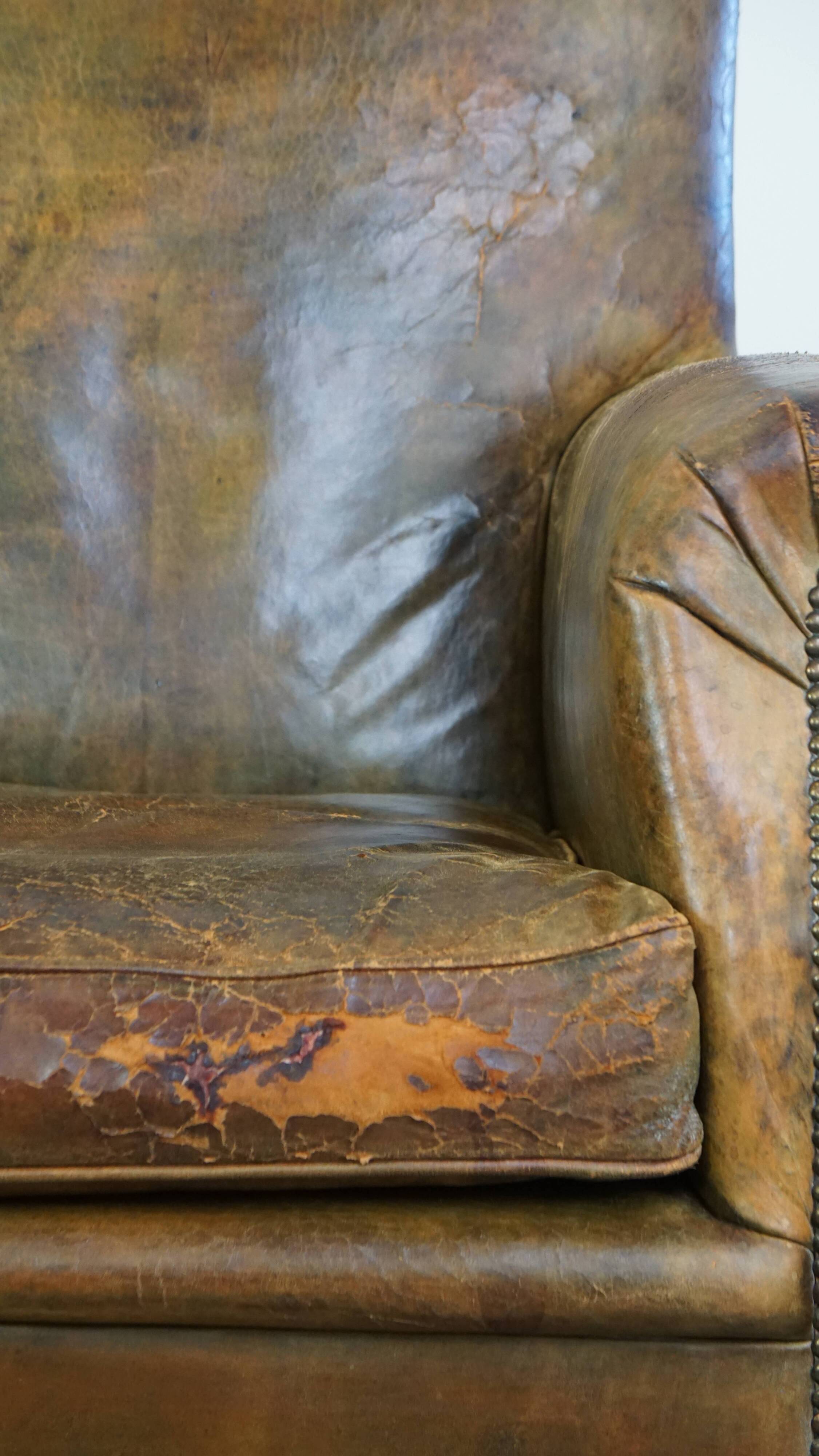 Green antique English cowhide leather armchair on wheels